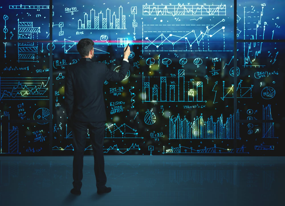 Businessman drawing business statistics on glass wall-2